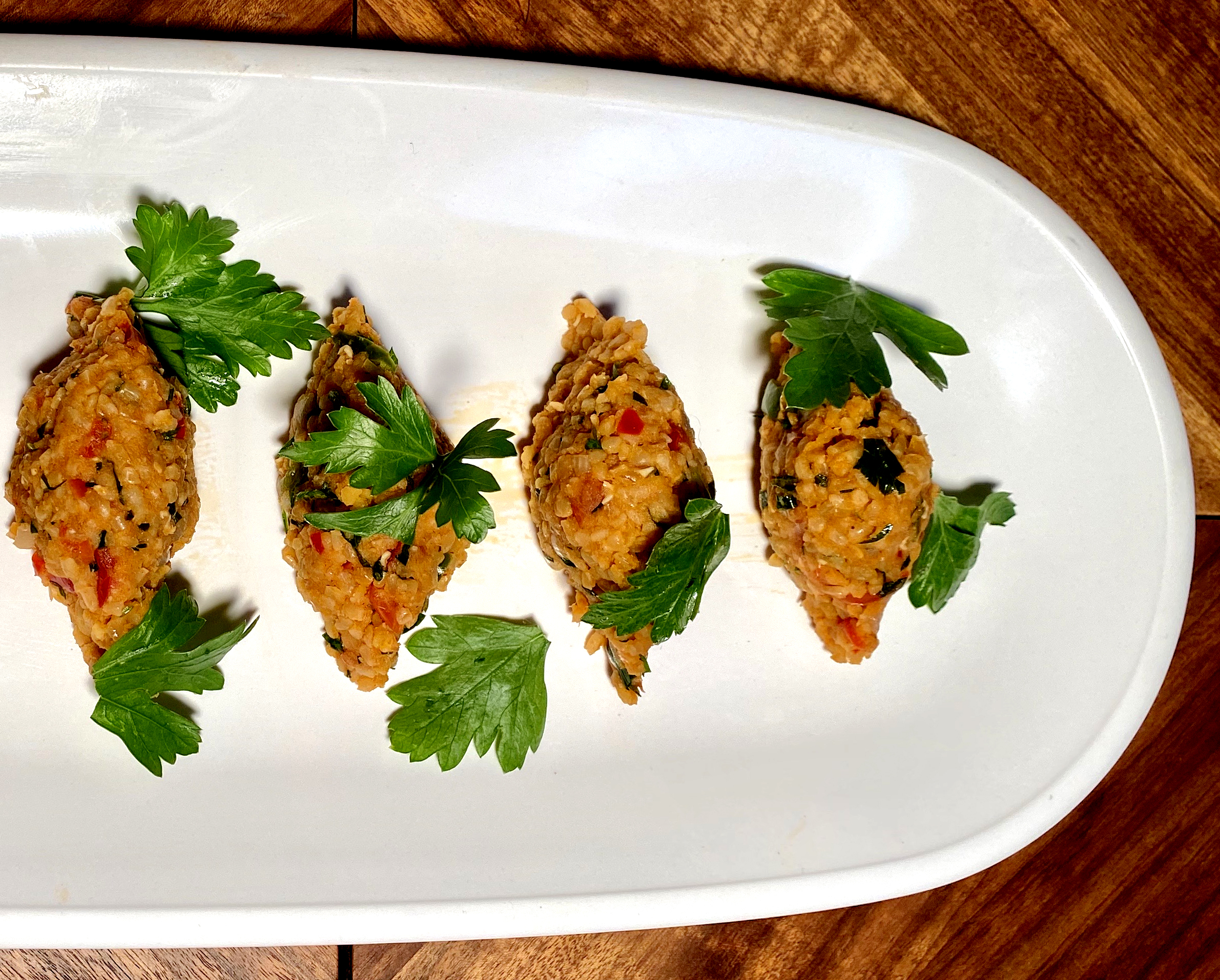 KIBBEH NEYEH: Syrian Bulgur Salad Torpedoes with Red Lentils, Scallions, Peppers and Cumin